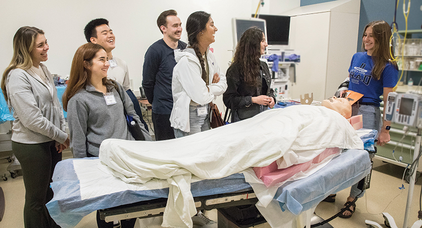 Duke School of Medicine student Brooke Schroeder explains the use of a mannequin in the simulation lab.