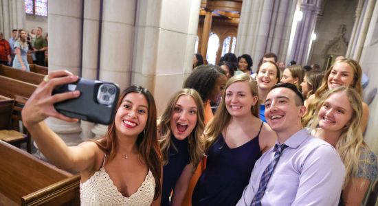 A group of five DPT students taking a selfie togehter in the Duke chapel 