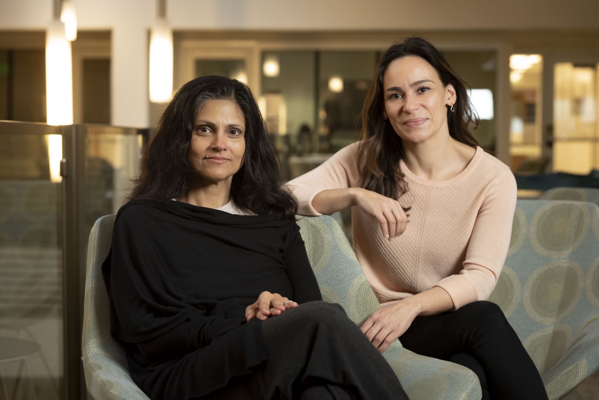 two women sitting on a couch