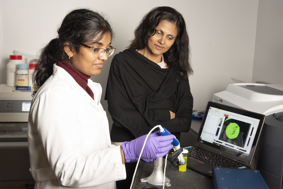 two women looking at optical technology