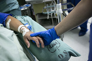 close-up of a physician holding a patient's hand
