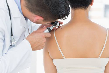 Physician looking at the shoulder of a patient. 