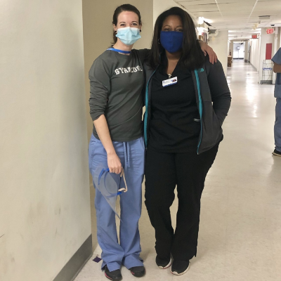 Moore-Byers standing next to a fellow student in the hospital, both wearing masks