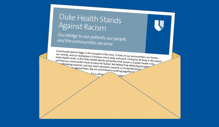 Envelope with the Duke anti-racism pledge sticking out the top