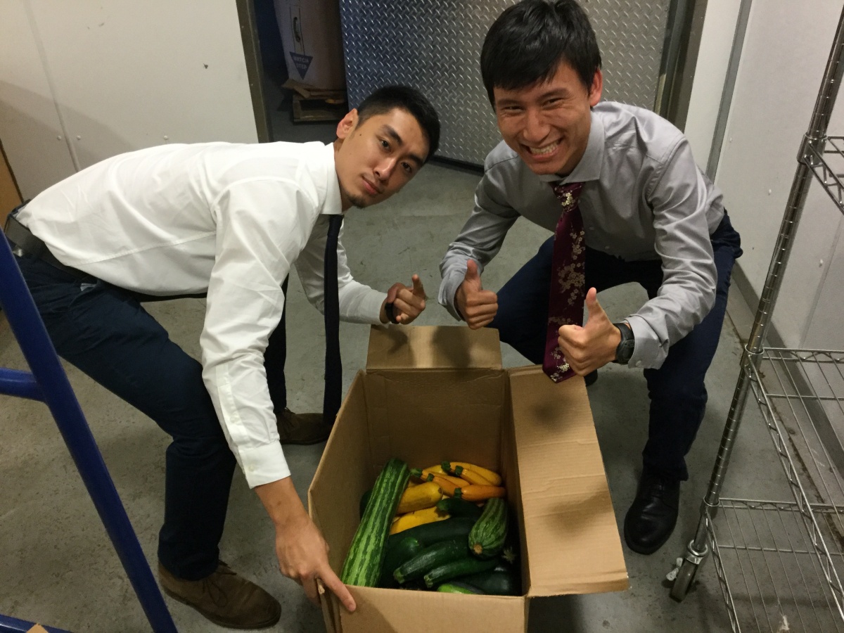 two medical students with box of produce