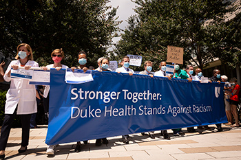 Dean Klotman and other Duke Leaders holding a banner that reads: Stronger Together, Duke Health Stands Against Racism" at the front of the solidarity march. 