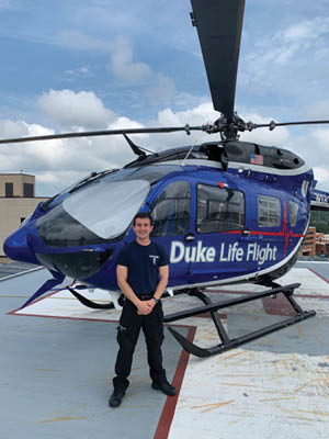 Tanzillo in front of a life flight helicoter.