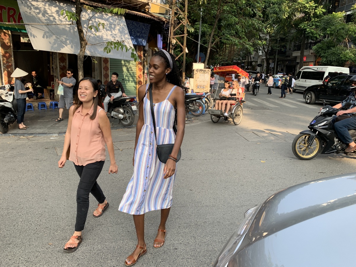 two women walk in a street