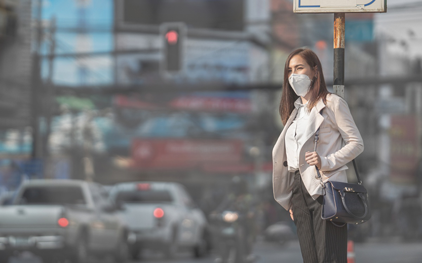 A woman encounters pollution on her work commute. Adobe Stock.