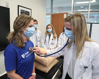 First year medical students practice patient exams.