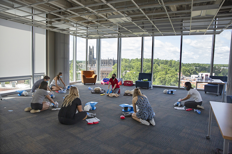 First-year medical students meet in a small groups, wear masks, and maintain social distancing during a Basic Life Support session in the Trent Semans Center for Health Education.