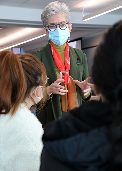 instructor speaking with two students