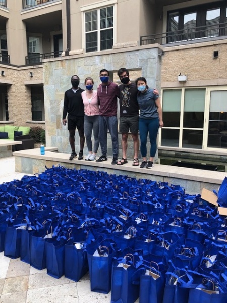 students with goodie bags, ready to hand out. 