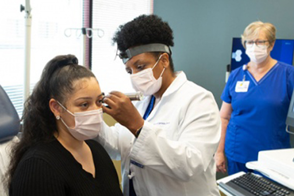 clinician examining a patient's ear