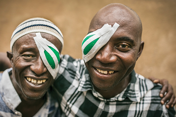 brothers hugging with eye patches