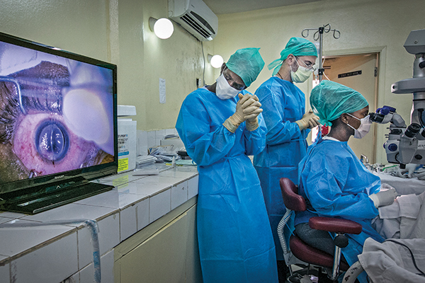 surgeons observe corneal transplant