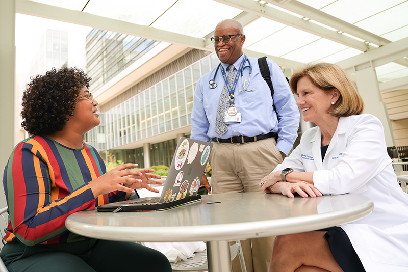 three people at outside table