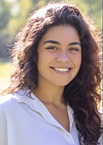 Headshot of student Raquel Garcia wearing white shirt with hair over one shoulder