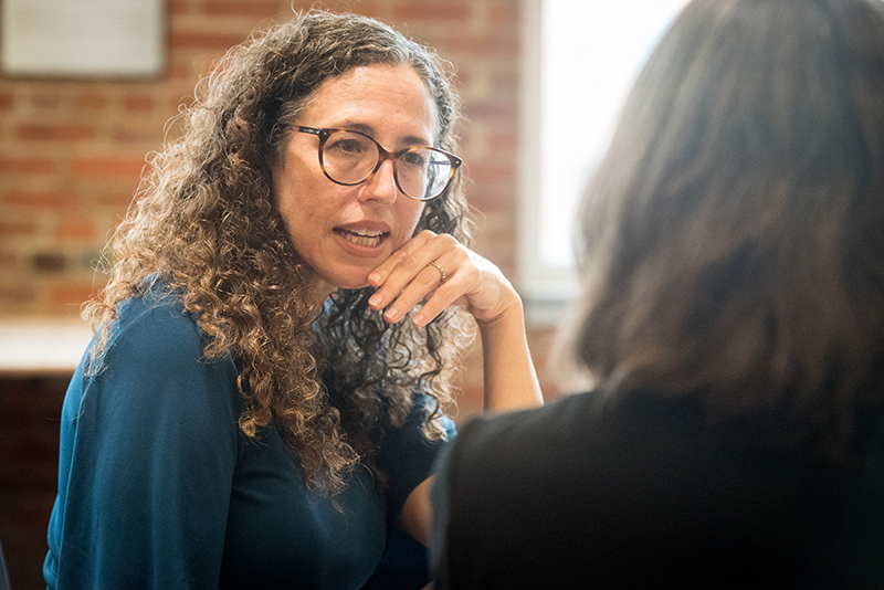 woman speaking to another person