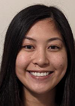 Headshot of Ashley Truong smiling at camera in front of white backdrop