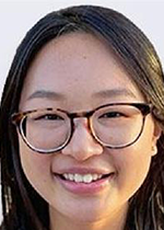 Headshot of Violet Tu smiling at camera in front of white backdrop