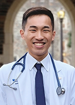 Headshot of student Daniel Wang wearing white coat and stethoscope