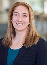 Headshot of student Carrie Diamond smiling at camera wearing black blazer over turquoise shirt