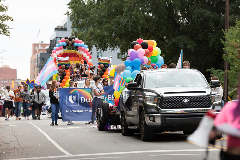 Duke health banner held by Duke representatives in the Durham Pride Parade.