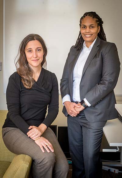 two women, one seated, one standing