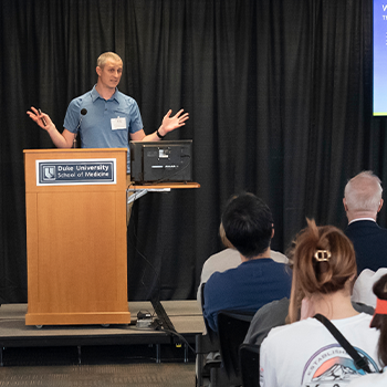 Craig Lowe, PhD, presenting to an audience