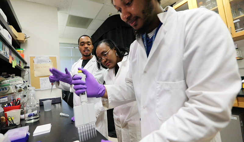 Moore in the lab with her research associates