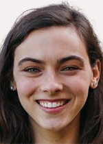 Headshot of Erin Brown smiling at camera wearing small stud earrings