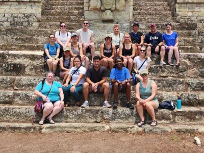 A grouo of students on ancient steps in Honduras