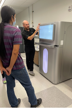 staff member from the sequencing core training a user on how to use the Illumina XPlus sequencer