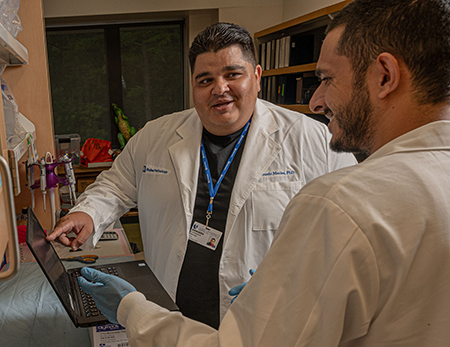 Macias in the lab with a colleague