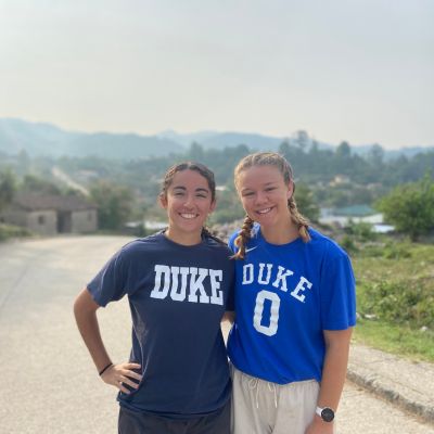 Two female students standing together on a mission learning trip