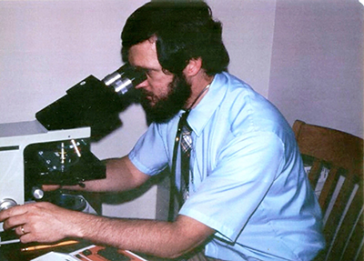 Berry looking through a microscope circa 1970s