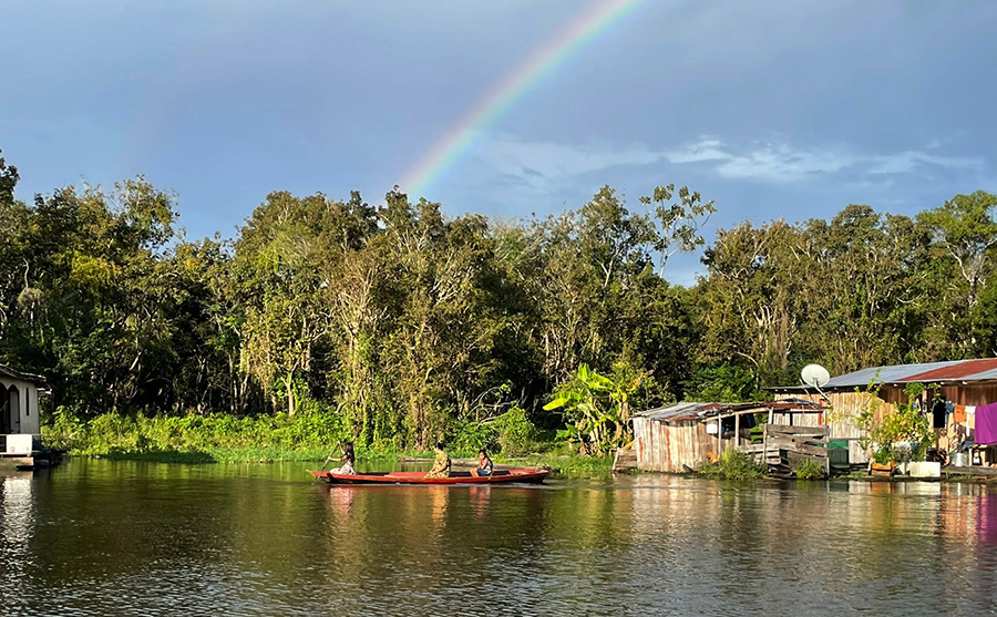 rainbow over a jungle village