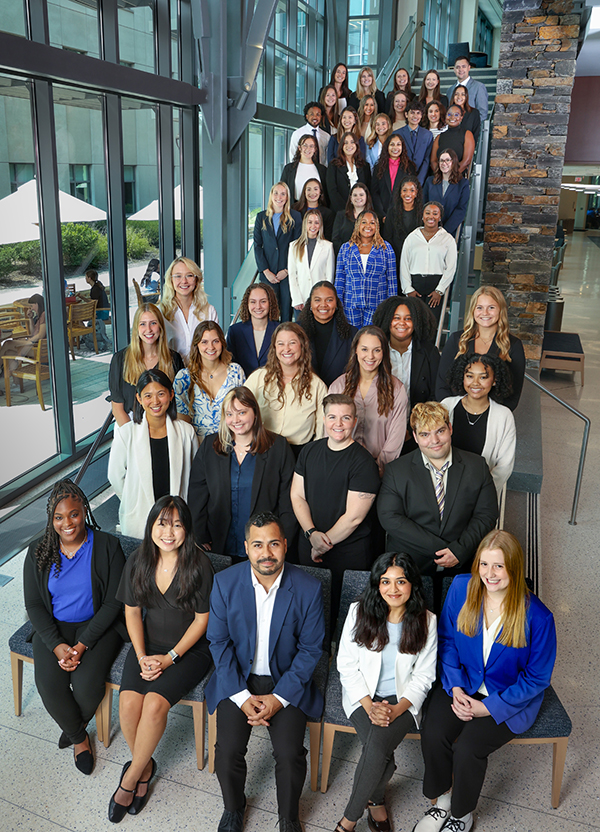 students standing on stairs posing for their class photo