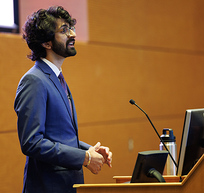 Srijan Bhasin speaking at a podium