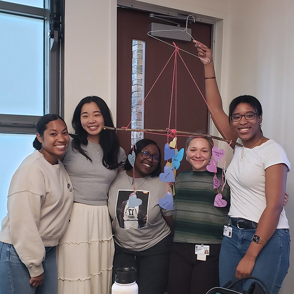 five students holding their mobile