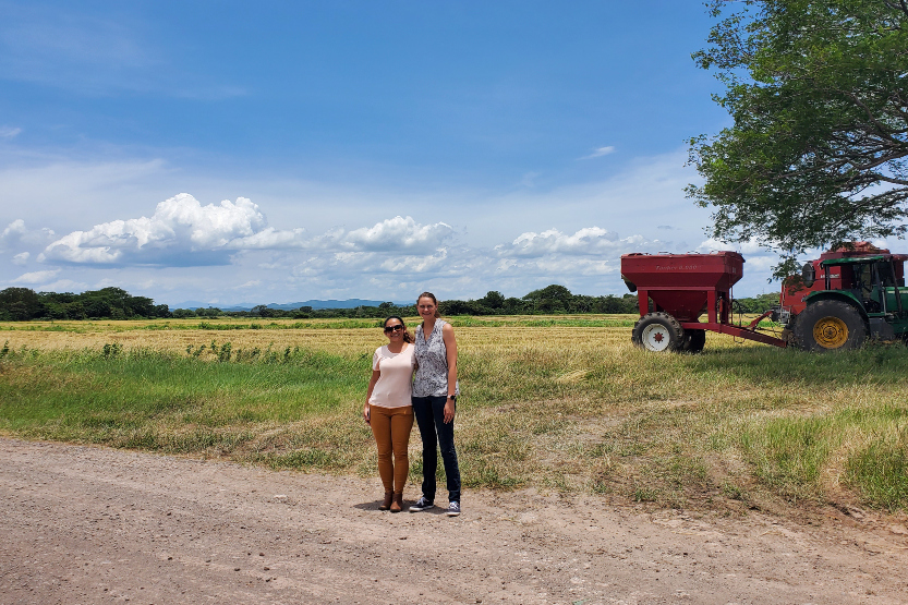 Anna Strasma, MD, MSc-GH, an assistant professor of medicine and nephrologist, poses with local study team member, Daylin Anchia Pastran at a rice field in Nicaragua.