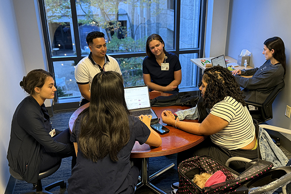 students and OTs around a table working