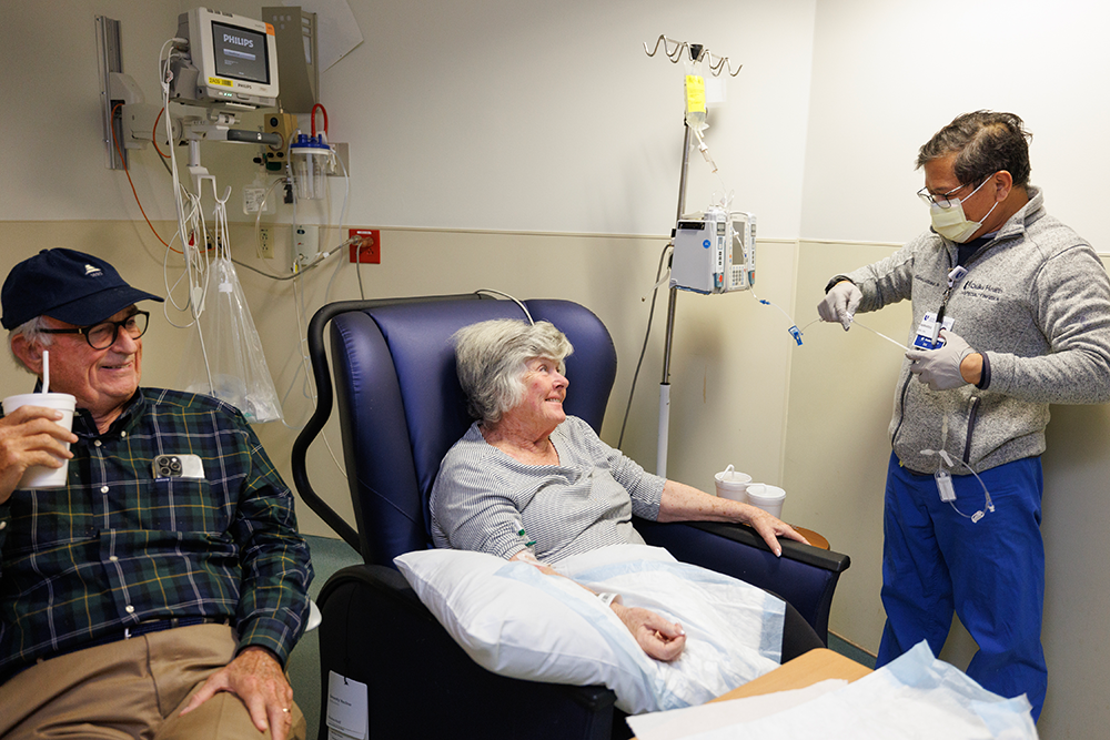 Barbara Goodmon receive an infusion treatment of lecanemab at Duke’s Specialty Infusion Clinic while she sits with her husband Jim Goodmon