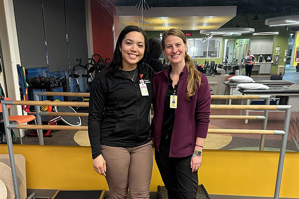 Elise and a woman smiling in a therapy studio