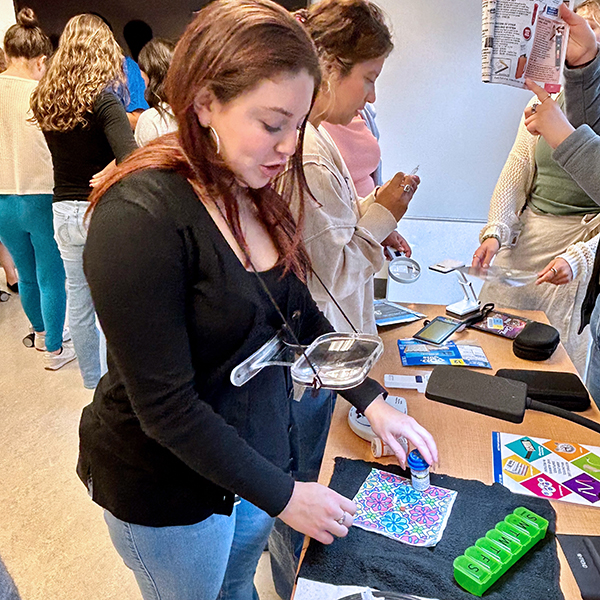 a student using low vision tools on a table