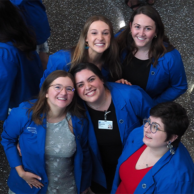 Grijalva and her classmates in blue coats at the Occupational Therapy Doctorate Program coating ceremony