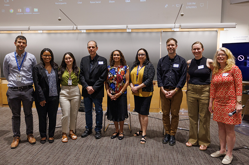 speakers and planners of the symposium pose for a group photo.