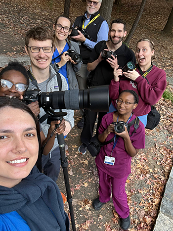 Emma and other students outside all holding cameras