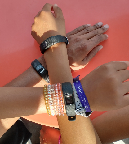 Children's arms with step counters on the wrists